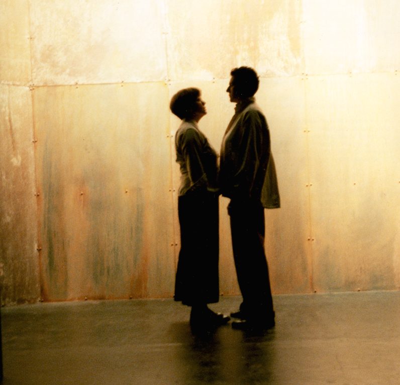 A man and a woman facing each other holding hands in the Purcell Room (1999)