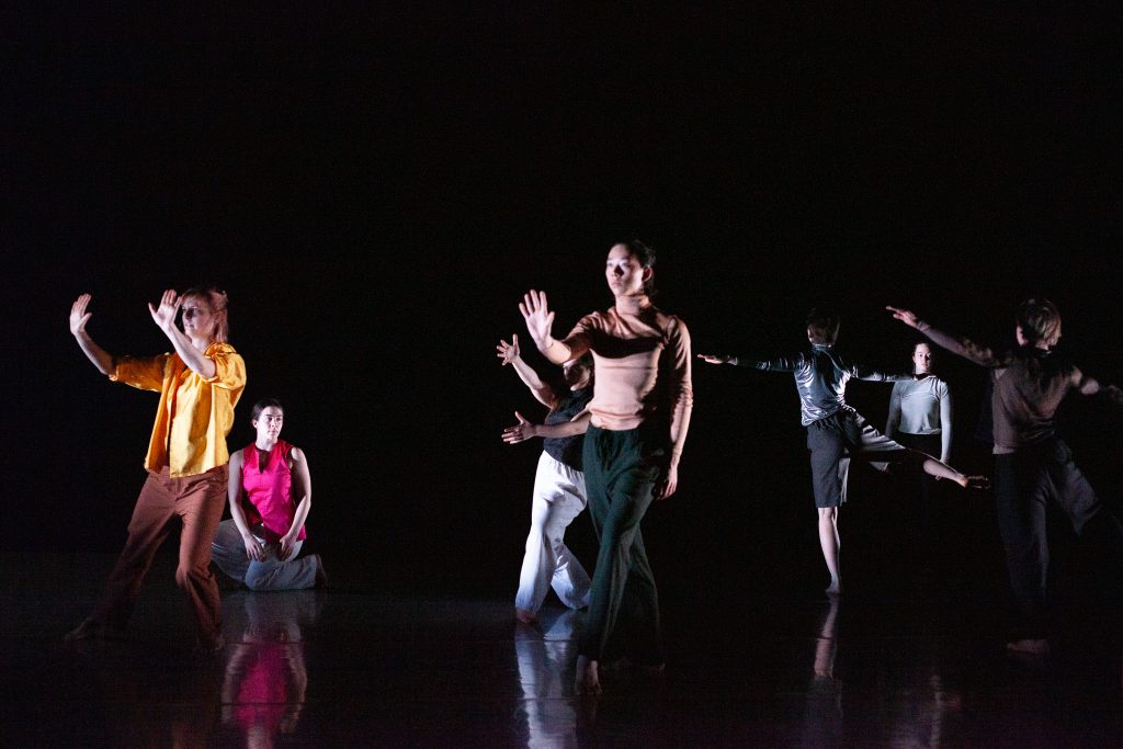 Students at the London Contemporary Dance School perform in a blacked-out room.