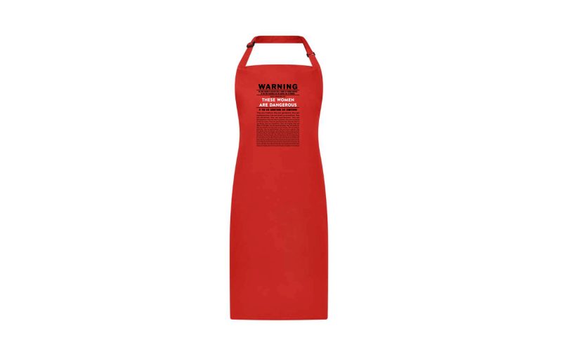 Exclusive apron printed for Clod Ensemble show Red Ladies. Warning Statement created by the Red Ladies is on the apron. The apron is bright red.