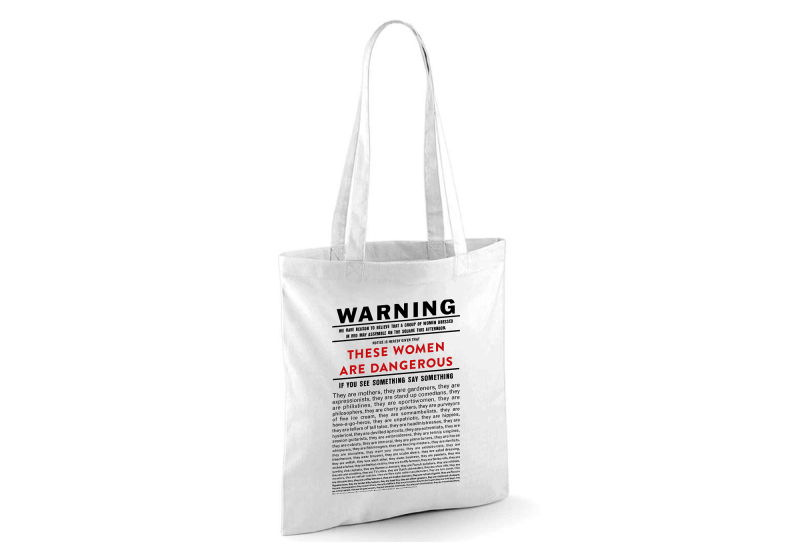 Exclusive tote bag from Clod Ensemble show Red Ladies printed with the Red Ladies warning statement on the front.